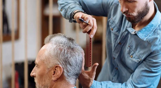Senior man getting haircut