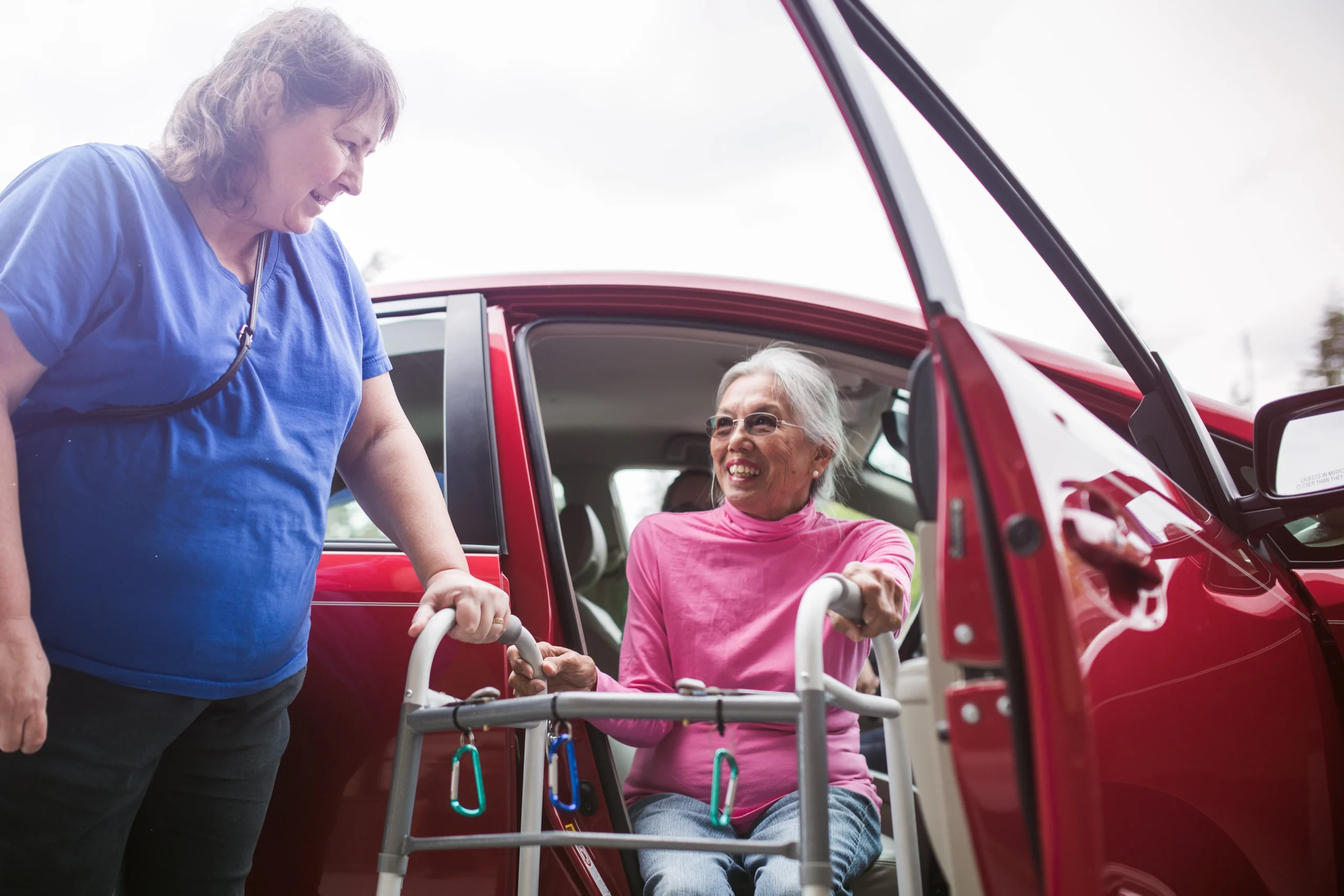 Senior woman with walker getting out of car